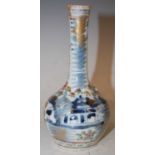 A Chinese porcelain famille rose Canton bottle vase, Qing Dynasty, decorated with a pair of Shishi