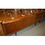A teak sideboard and extending dining table
