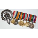 Great War interest; a bar of seven miniature medals, together with a Regimental white metal cap