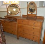 A 20th century oak mirror back dressing chest of two short over two long drawers, raised on castors,