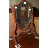 An early 20th century mahogany shield shaped dressing table mirror