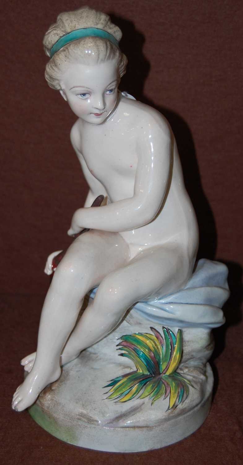 A Continental pottery figure group modelled as Cupid, painted marks 'Gien', 25.5cm high