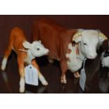 A Beswick model of a Hereford bull and calf