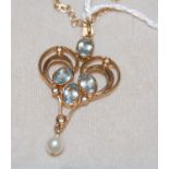 A 9ct gold aquamarine, diamond and pearl set Art Nouveau style pendant suspended on yellow metal