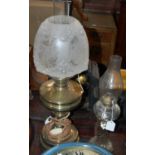 A brass paraffin lamp converted to electricity together with another glass paraffin lamp