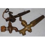 A collection of three vintage whisky barrel taps, one with original key attached to a piece of