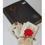 A late 19th/ early 20th century postcard/ photograph album containing interesting cards depicting
