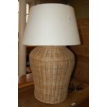 A basket weave table lamp and shade
