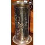 A brass embossed stick stand depicting musicians