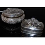 An Indian white metal oval shaped pill box, the hinged cover with mirrored underside, together