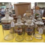 A collection of assorted clear glass apothecary jars