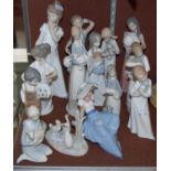 A group of fourteen Lladro, Nao and other similar porcelain figure groups