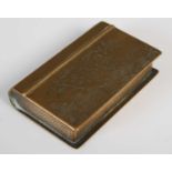 An unusual brass snuff box in the form of a book,