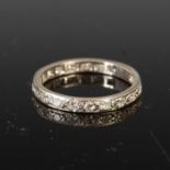 A mid 20th century white metal and diamond eternity ring,