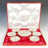 A set of seven Middle Eastern white metal lotus shaped bowls, 20th century,
