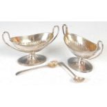A pair of Victorian silver canoe shaped salts and original corresponding salt spoons,