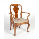An early 20th century Queen Anne walnut elbow chair for a child,