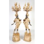 A pair of Blackamoor figural floor-standing candelabra, late 19th / early 20th century,