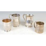 A group of four silver assorted late 19th/ early 20th century christening mugs,