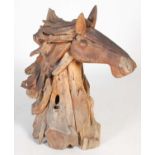 A naturalistic wood garden ornament in the form of a horse's head,