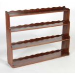 A George III mahogany graduated hanging shelf,