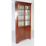 A late George III mahogany two-part corner cupboard,