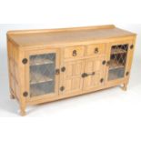 An oak sideboard in the manner of Robert 'Mouseman' Thompson,