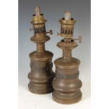 A pair of late 19th century bronzed paraffin burning oil lamps,