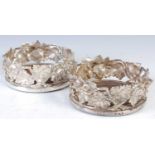 A pair of Elkington & Co silver plated bottle stands,
