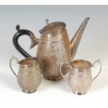 A late 19th / early 20th century Indian white metal three-piece tea set,
