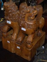 A pair of carved wooden Chinese Dogs of Foo/ Temple Dogs.