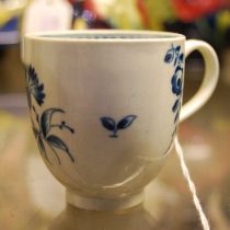 An 18th century Worcester porcelain blue and white teacup decorated with scattered foliate sprays,