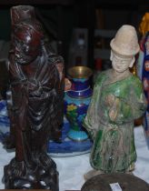 A Chinese pottery nodding head figure of a tomb attendant, together with a carved wooden figure of a