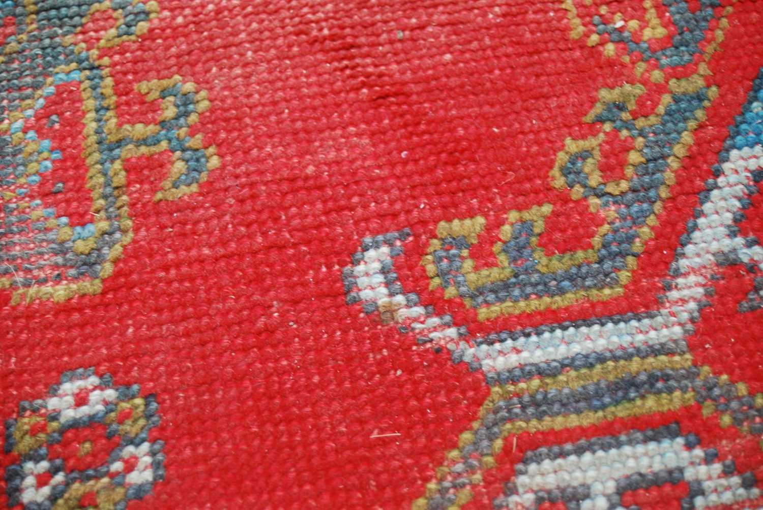 A late 19th century red ground Ushak carpet, the rectangular field decorated with three rows of - Image 9 of 9