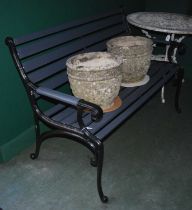 A black painted wrought metal garden bench with painted grey wooden slats.