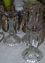 A pair of antique glass lustres with purple tops, together with another antique clear class