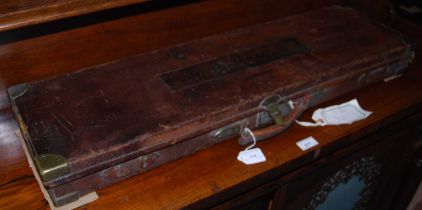 A vintage leather and brass bound gun case, the lid with initials 'R.H.M', retailers 'Jopseph