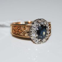 A 9ct gold, sapphire and diamond chip cluster ring, ring size O, gross weight 4.7 grams.