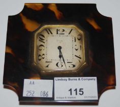 An early 20th century faux tortoiseshell eight-day Swiss made travelling bedside clock with