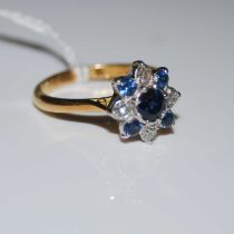 A white and yellow metal, sapphire and diamond cluster ring, stamped '18CT', ring size Q, gross