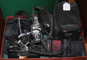 A collection of assorted vintage camera equipment to include two similar modelled Canon AE-1