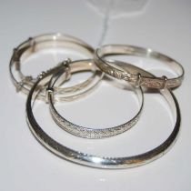 A collection of assorted white metal bangles/ bracelets.