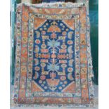 A Persian rug, late 19th / early 20th century, the rectangular blue ground decorated with stylised