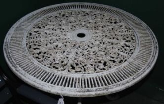 A white painted metal garden table with pierced details.