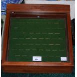 A stained wooden ring display case.