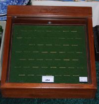 A stained wooden ring display case.