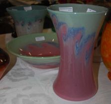 Three pieces of Vasart glassware comprising a vase and bowl, both mottled green and pink with a band