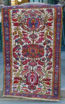Two small Persian rugs, comprising a brown ground rug decorated with four triangular shaped motifs