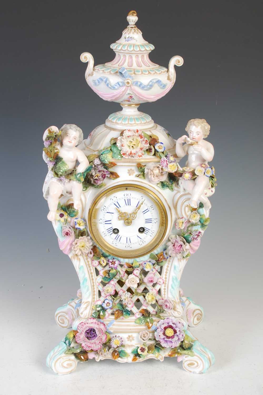 A late 19th / early 20th century Dresden porcelain mantle clock, the circular blue and white