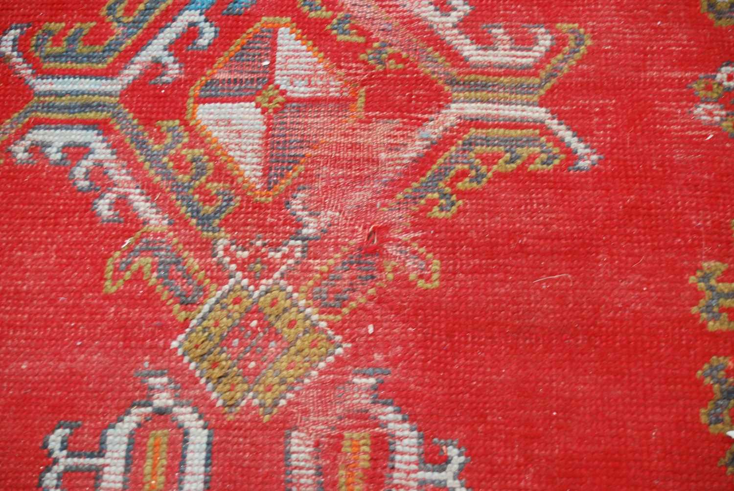 A late 19th century red ground Ushak carpet, the rectangular field decorated with three rows of - Image 7 of 9